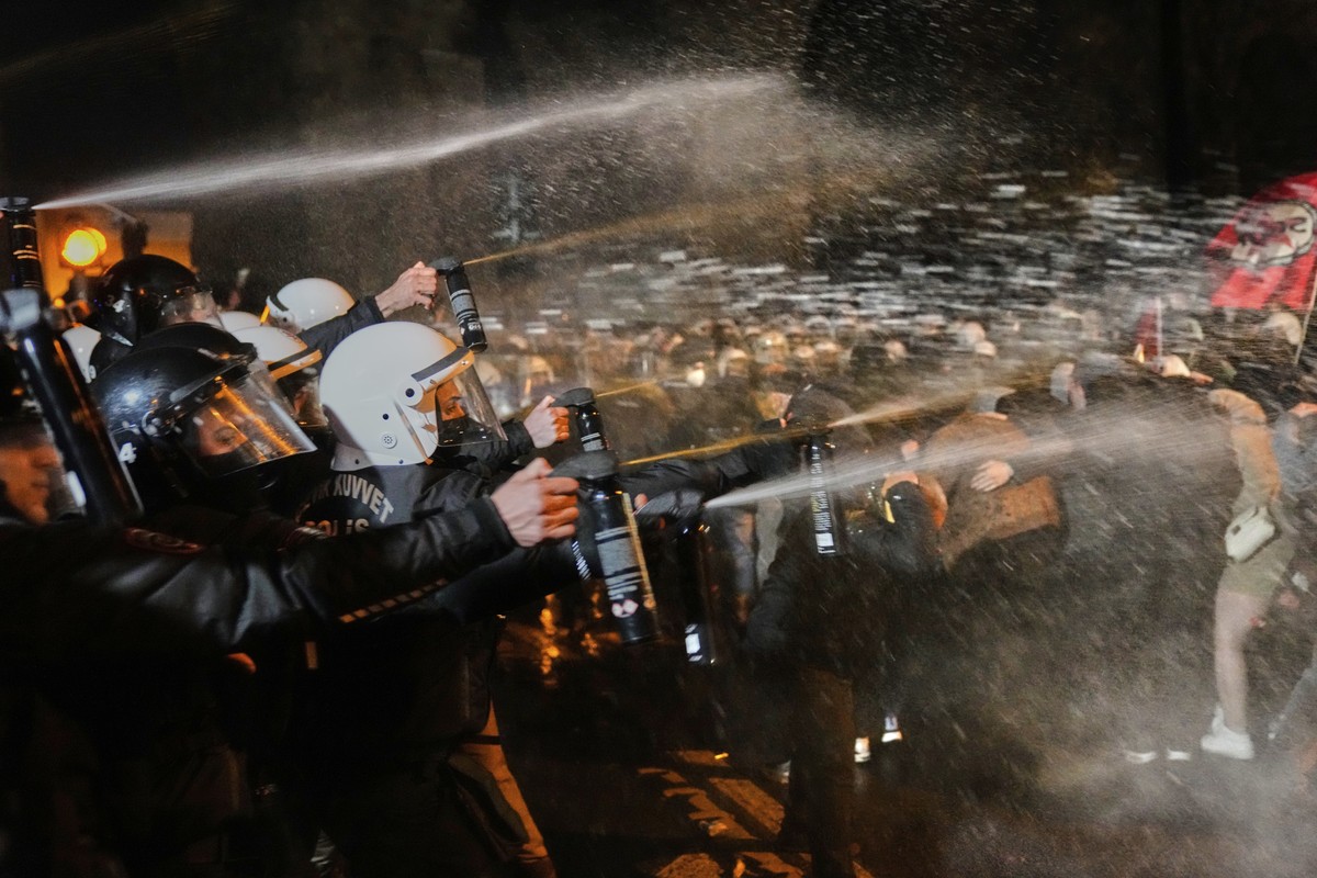 Police officers use pepper spray during clashes with people as they protest against the arrest of Istanbul's Mayor Ekrem Imamoglu, in Istanbul, Turkey, Friday, March 21, 2025. (AP Photo/Khalil Ha ...