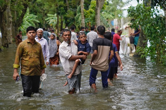 People wading through the flood waters, in search of shelter, in Feni.

Catastrophic floods in southeastern Bangladesh, particularly in Noakhali, Feni, and Khagrachari, are wreaking havoc, in August 2 ...