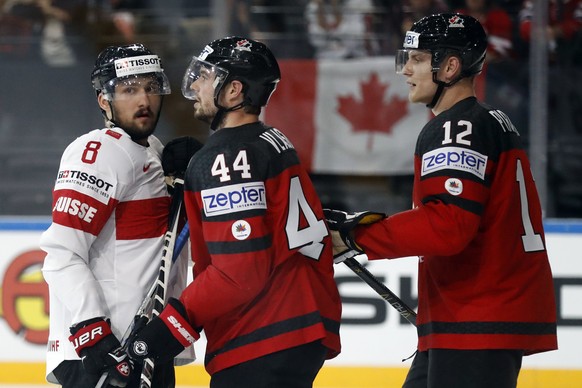 epa05962161 Vincent Praplan of Switzerland argues with Marc-Edouard Vlasic (C) of Canada during the IIHF Ice Hockey World Championship 2017 group B preliminary round game between Canada and Switzerlan ...