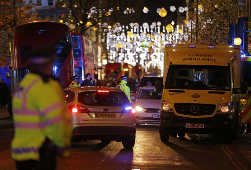 Police officers and vehicles block Oxford Street in the west end of London after Oxford Circus station was evacuated Friday Nov. 24, 2017. British police flooded London&#039;s busy Oxford Circus area  ...