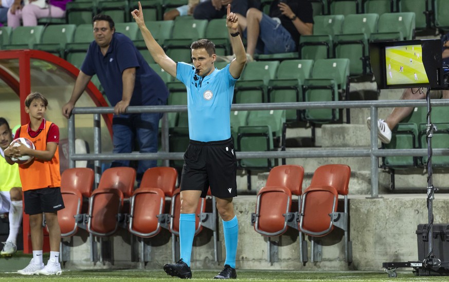 The referee Sven Wolfensberger gestures after checking the VAR screen, during the Super League soccer match of Swiss Championship between FC Sion and FC Servette, at the Stade de Tourbillon stadium, i ...