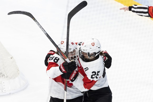 Switzerland&#039;s forward Phoebe Staenz, left, celebrates her goal with teammate Switzerland&#039;s forward Alina Mueller, right, after scoring the 0:1, during the women&#039;s ice hockey quarterfina ...