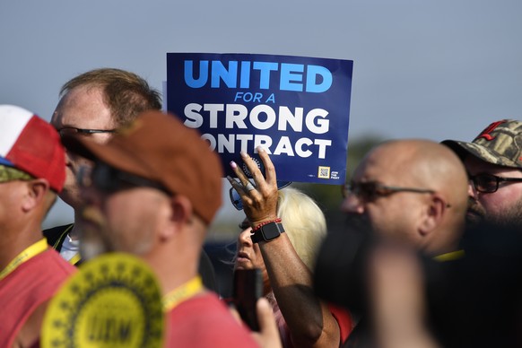 File - A member holds up a sign at a rally by United Auto Workers Local 863 in Louisville, Ky., on Aug. 24, 2023. eaders of the UAW union are considering targeted strikes at a small number of factorie ...
