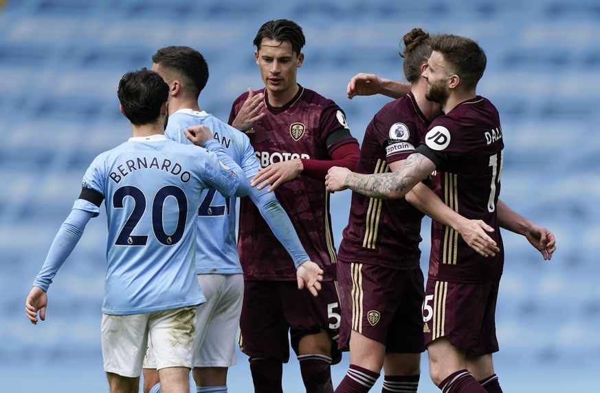 Leeds United players celebrate after defeating Manchester City in their English Premier League soccer match at Etihad Stadium, Manchester, England, Saturday April 10, 2021. (AP Photo/Tim Keeton,Pool)