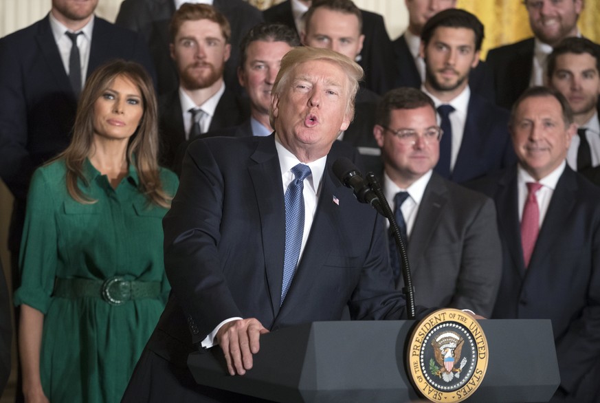 epa06257649 US President Donald J. Trump (C) delivers remarks in front of First Lady Melania Trump (L) during a ceremony welcoming the Stanley Cup Champions Pittsburgh Penguins in the East Room of the ...