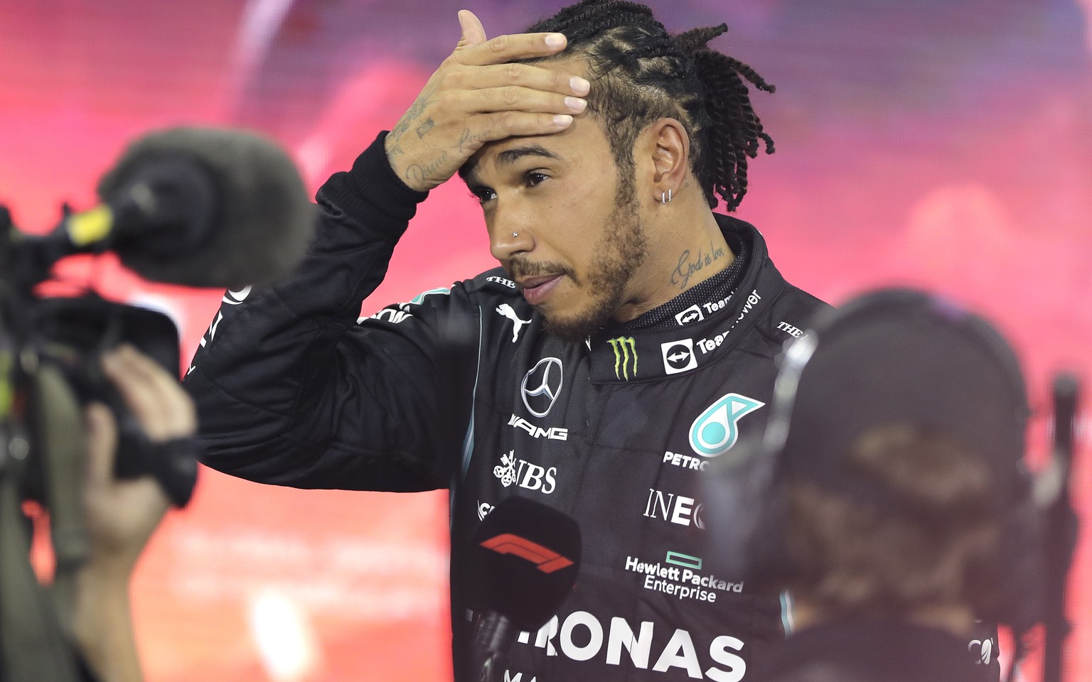 FILE - Mercedes driver Lewis Hamilton of Britain reacts after finishing second in the Formula One Abu Dhabi Grand Prix in Abu Dhabi, United Arab Emirates, Sunday, Dec. 12. 2021. After losing the Formu ...