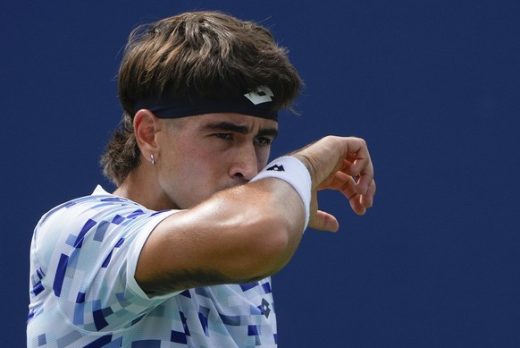 Francisco Comesana, of Argentina, wipes sweat from his face between points during a match against Dominic Stricker, of Switzerland, during the first round of the U.S. Open tennis championships, Monday ...