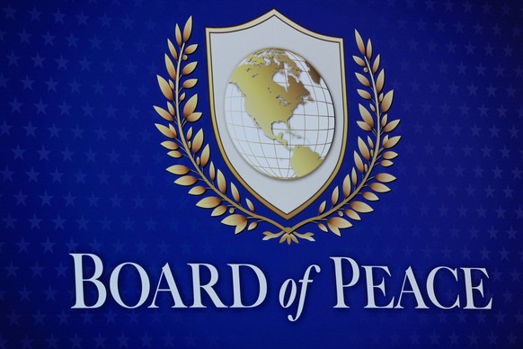 A logo is shown prior to the Board of Peace charter announcement by President Donald Trump at the Annual Meeting of the World Economic Forum in Davos, Switzerland, Thursday, Jan. 22, 2026. (AP Photo/E ...