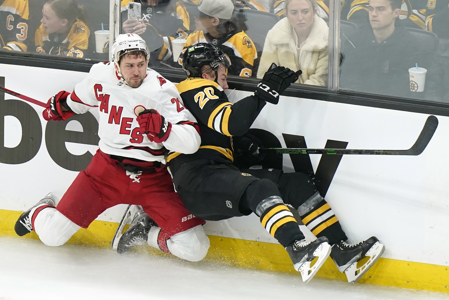 Carolina Hurricanes&#039; Nino Niederreiter, of Switzerland, left, slams Boston Bruins&#039; Curtis Lazar, right, into the boards in the third period of Game 4 of an NHL hockey Stanley Cup first-round ...