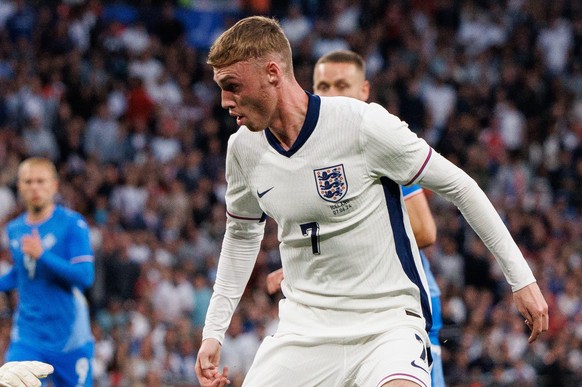 epa11396784 Cole Palmer of England in action against goalkeeper Hakon Rafn Valdimarsson (L) of Iceland during the friendly international soccer match between England and Iceland in London, Britain, 07 ...