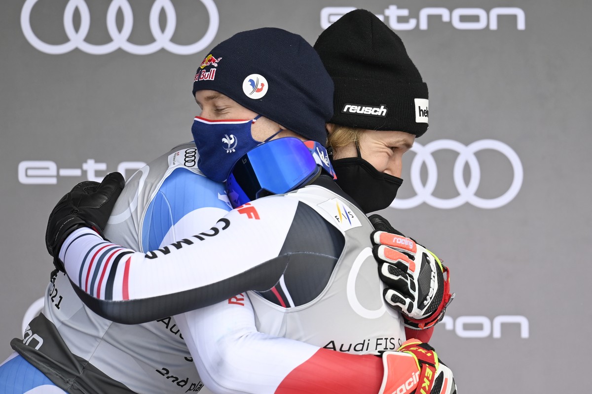 epa09085931 Alexis Pinturault of France celebrates winning the overall men's Giant Slalom competition with second placed Marco Odermatt (R) of Switzerland during the award ceremony at the FIS Alp ...