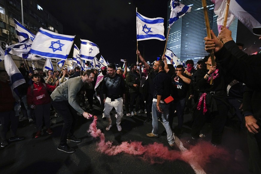 Demonstrators block highway during a protest against plans by Prime Minister Benjamin Netanyahu&#039;s government to overhaul the Israel&#039;s judicial system, in Tel Aviv, Israel, Saturday, March 18 ...