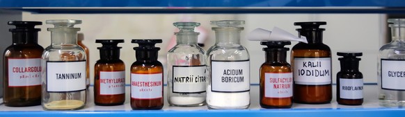 Composition of medicine bottle on white background in pharmacy