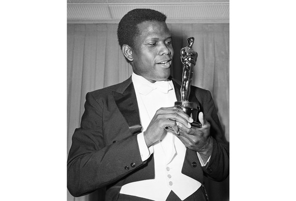 FILE - Actor Sidney Poitier poses with his Oscar for best actor for &quot;Lillies of the Field&quot; at the 36th Annual Academy Awards in Santa Monica, Calif. on April 13, 1964. Poitier, the groundbre ...