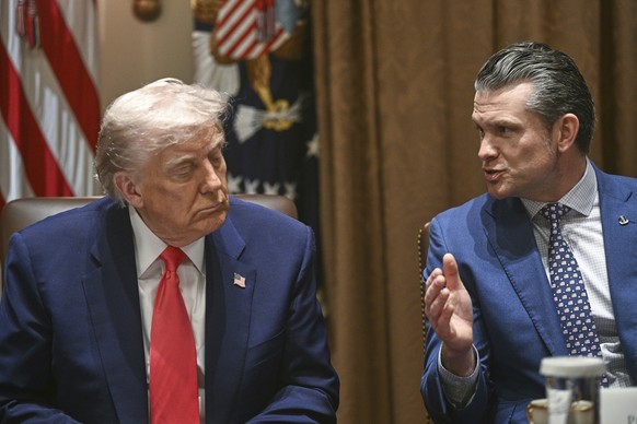 President Donald Trump listens as Defense Secretary Pete Hegseth speaks at a cabinet meeting in the Cabinet Room of the White House, Thursday, April 10, 2025, in Washington (Pool via AP)
Trump
