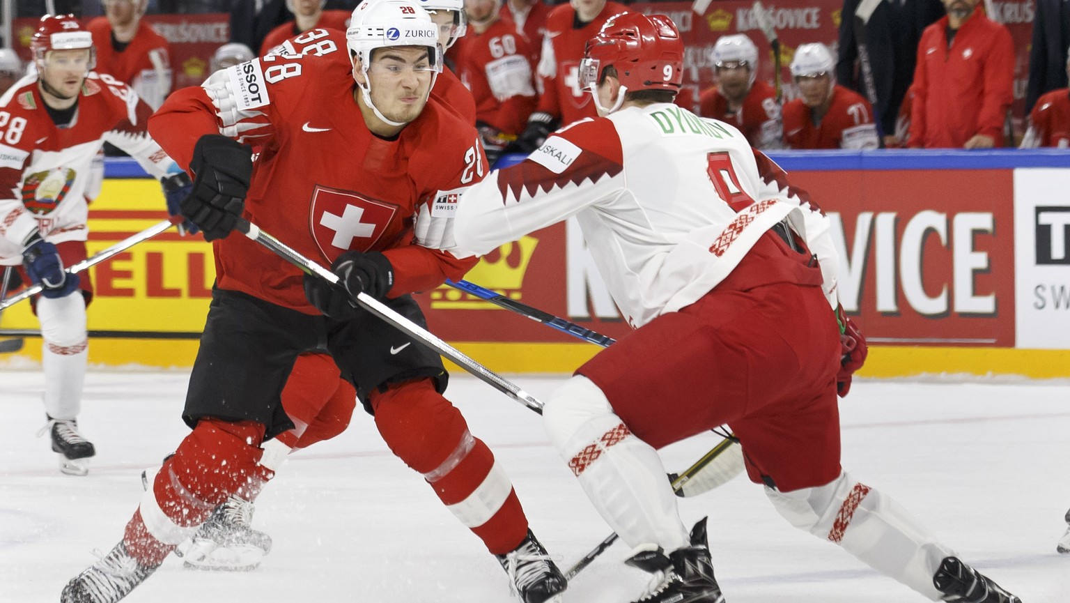 Switzerland&#039;s forward Timo Meier, left, vies for the puck with Belarus&#039; defender Roman Dyukov, right, during the IIHF 2018 World Championship preliminary round game between Switzerland and B ...