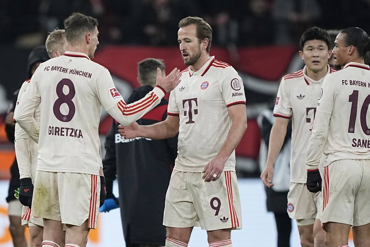 Bayern's Leon Goretzka, left, Bayern's Harry Kane, centre, Bayern's Kim Min-jae, Bayern's Leroy Sane, right, react after the German Bundesliga soccer match between Bayer Leverkusen ...