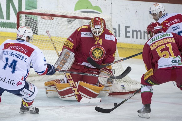 Tigers Goalie Ivars Punnenovs, und Flurin Randegger, rechts, kaempfen um den Puck, gegen die Lions Chris Baltisberger, links, und Luca Cunti, rechts, waehrend dem Eishockey National League A Spiel zwi ...