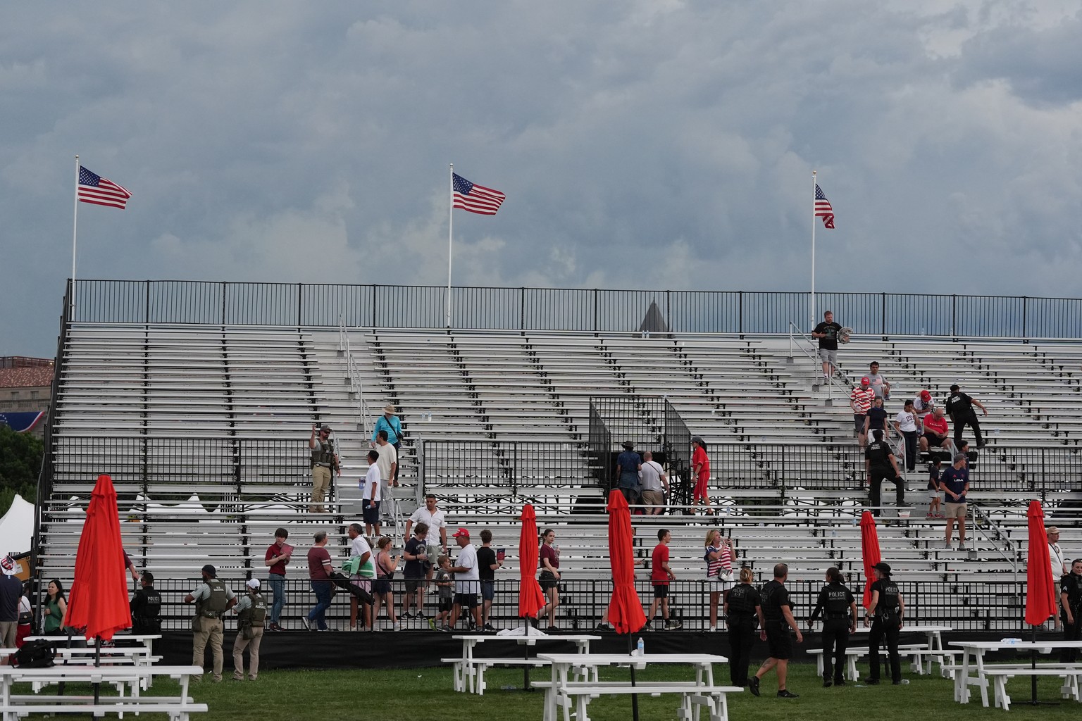 Law enforcement secure the area as people evacuate because of incoming storms that will delay the program at a Salute to America Independence Day event honoring the nation's 250th anniversary, Sa ...