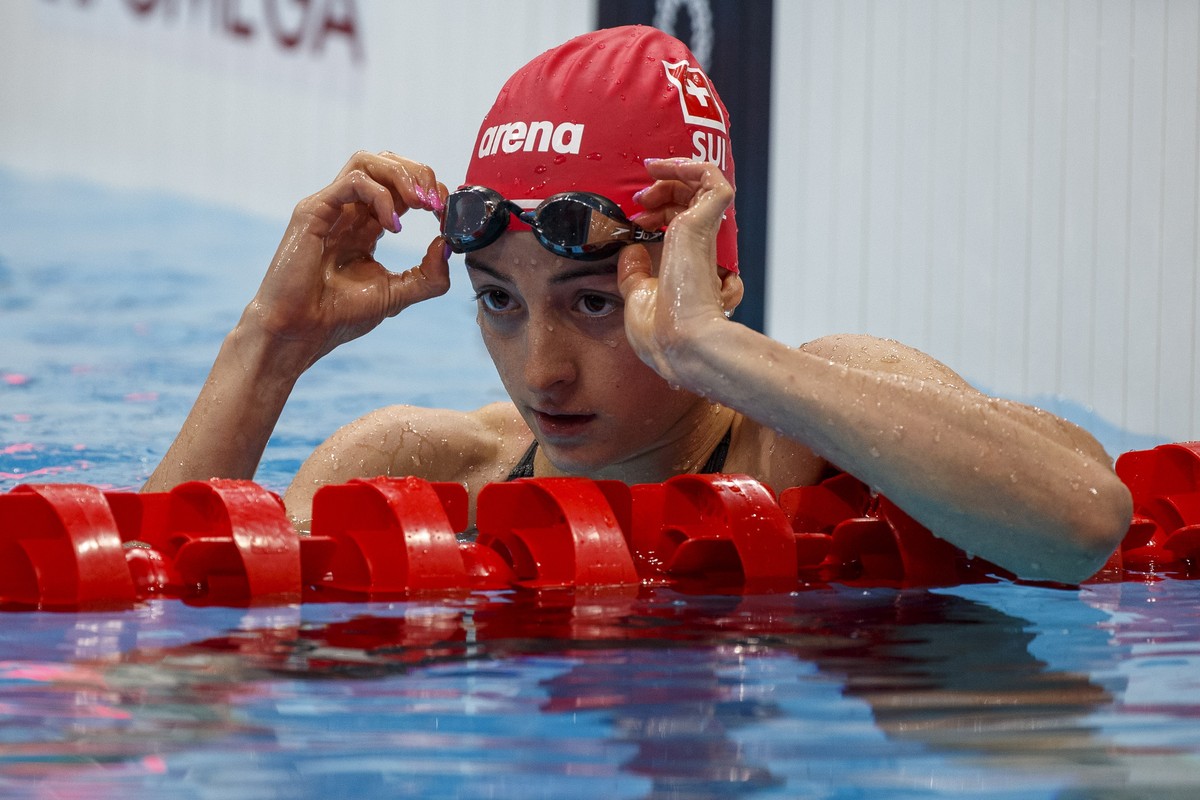 epa09364842 Lisa Mamie of Switzerland reacts after competing in the women's 100m Breaststroke Heats during the Swimming events of the Tokyo 2020 Olympic Games at the Tokyo Aquatics Centre in Toky ...