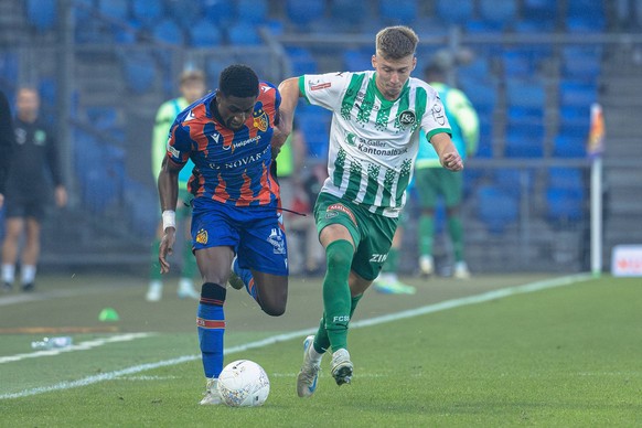 Basel, Switzerland, October 20st 2024: A duel between Joe Mendes 17 Basel and Christian Witzig 7 FCSG during the Super League football match between FC Basel 1893 and FC St. Gallen at St. Jakob-Park i ...