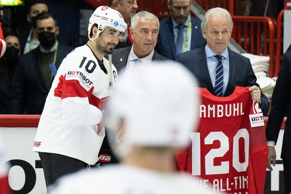 Switzerland&#039;s Andres Ambuehl, world record holder with 120 World Championship games, left, and IIHF president Canadien Luc Tardif, center, before the Ice Hockey World Championship group A prelimi ...