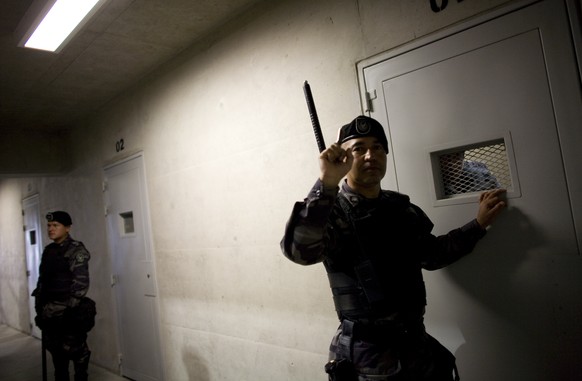 FILE - This March 30, 2011 file photo, show security guard inside the new maximum security pavilion at La Picota prison during a press tour, in Bogota, Colombia. More than 100 rebels of the Revolution ...