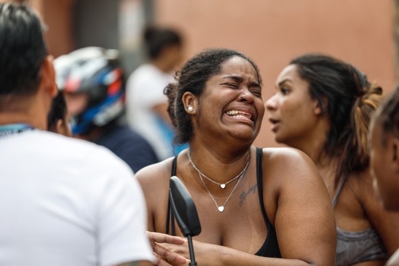 epa12488107 A woman cries outside Getulio Vargas Hospital after a relative was killed during a police operation in Rio de Janeiro, Brazil, 28 october 2025. The death toll in the operation has risen to ...