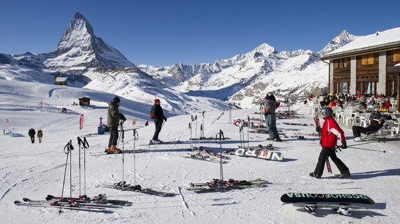 Skiers ride down the slopes at Riffelberg with Mount Matterhorn in the background, pictured on January 16, 2012, in Zermatt in the canton of Valais, Switzerland. This season has made tourists happy wi ...