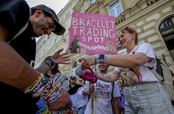 Swifties trade bracelets in the city centre in Vienna on Thursday, Aug.8, 2024. Organizers of three Taylor Swift concerts in the stadium in Vienna this week called them off on Wednesday after official ...
