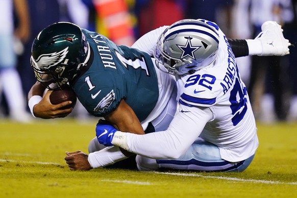 Dallas Cowboys&#039; Dorance Armstrong tackles Philadelphia Eagles&#039; Jalen Hurts during the first half of an NFL football game Sunday, Oct. 16, 2022, in Philadelphia. (AP Photo/Matt Slocum)
