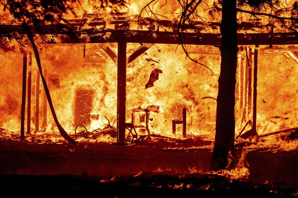 Fire consumes a structure as the Sugar Fire, part of the Beckwourth Complex Fire, tears through Doyle, Calif., on Saturday, July 10, 2021. Pushed by heavy winds, the fire came out of the hills and des ...