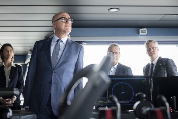 epa12844726 Swiss Federal Councillor and Minister of Defence Martin Pfister (L) watches a demonstration on the Finnish Coastguard vessel Turva, in Helsinki, Finland, 23 March 2026. Federal Councillor  ...