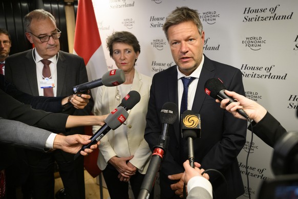 Switzerland&#039;s Simonetta Sommaruga, center, Federal councillor for the environment, transport, energy and communications and Switzerland&#039;s Guy Parmelin, left, Federal councillor for economic  ...