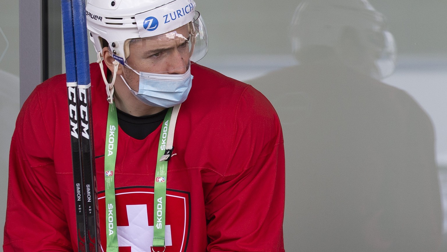 Switzerland&#039;s players forward Dario Simion, left, forward Nico Hischier, center, and forward Sven Andrighetto, right, wait their buses at the Olympic Sports Center for going to a Swiss team train ...