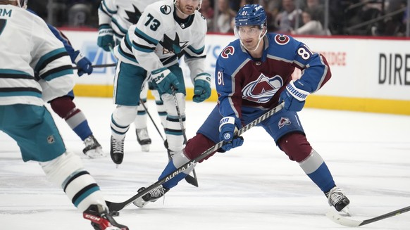 Colorado Avalanche center Denis Malgin, center, looks to pass the puck as San Jose Sharks center Nico Sturm, front, and center Noah Gregor defend in the third period of an NHL hockey game Tuesday, Mar ...