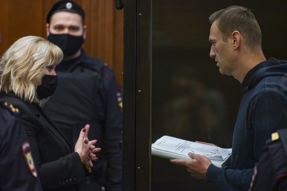 epa08980989 A handout photo made available by Moscow's Citiy Court Press Service shows Russian opposition leader Alexei Navalny (R) speaks with his lawyer Olga Mikhailova (L) before a hearing in the M ...