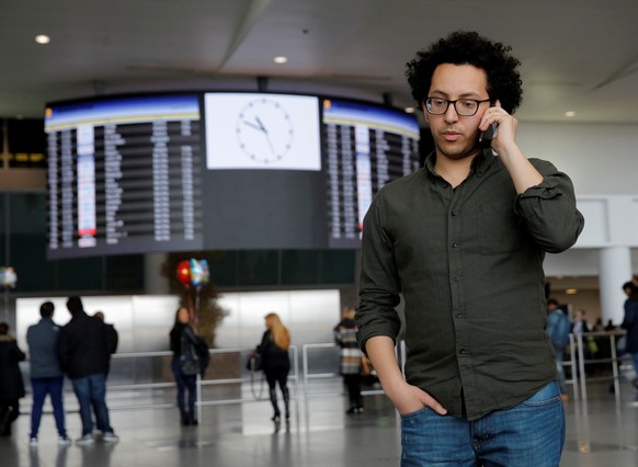 Mark Doss, Supervising Attorney for the International Refugee Assistance Project at the Urban Justice Center speaks on his cell phone at John F. Kennedy International Airport in Queens, New York, U.S. ...