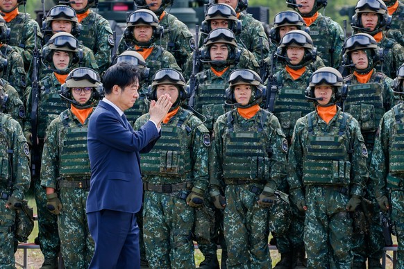 epa12494535 Taiwanese President William Lai (Lai Ching-te) reacts next to Taiwanese soldiers during the launching ceremony for the M1A2T Tank Battalion, in Hukou Township, Hsinchu County, Taiwan, 31 O ...