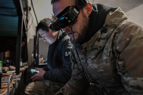epa11932621 Drone pilots of the 68th Brigade of the Ukrainian Army control their unmanned aerial vehicles during an attack mission against Russian lines at a position along a frontline in Pokrovsk, Uk ...