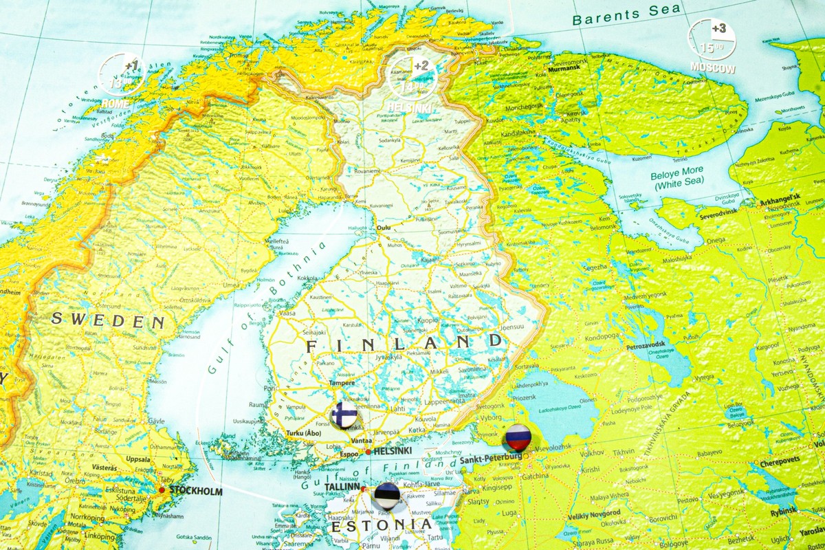 Finland national flag pinned on Europe map. Macro Close up picture of country on a colorful and Blurry World Map Globe with focus to capital Helsinki. Push pin on map, marker of destination xkwx issue ...