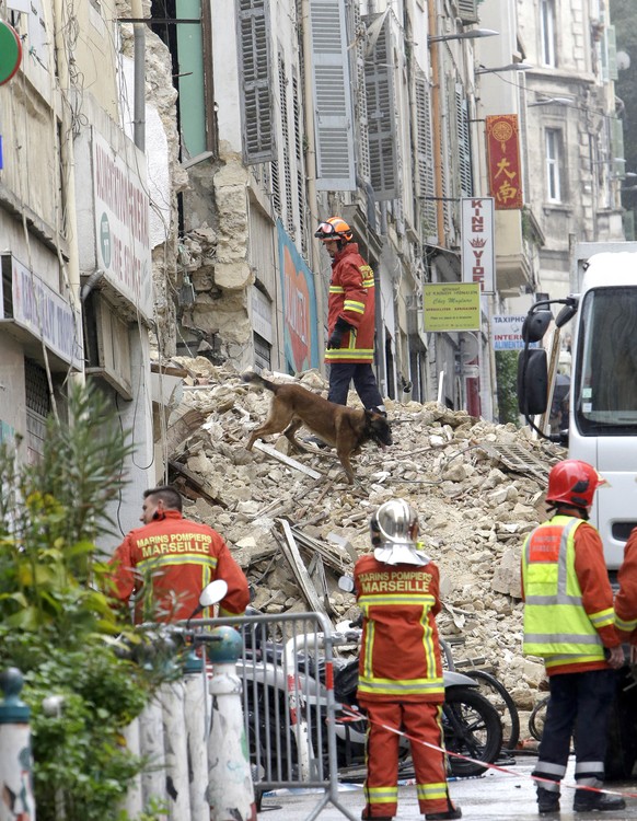 Firefighters work at the scene where buildings collapsed in Marseille, southern France, Monday, Nov. 5, 2018. Two buildings collapsed in the southern city of Marseille on Monday, leaving a giant pile  ...