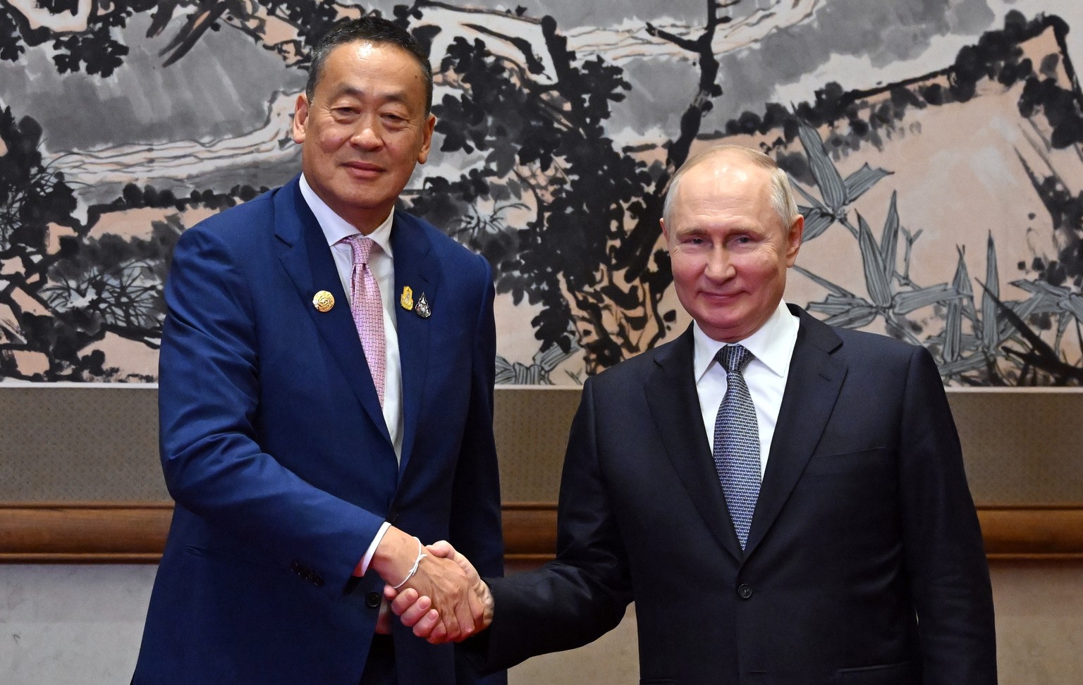 epa10923350 Thai Prime Minister Settha Thavisin (L) and Russian President Vladimir Putin shake hands before their meeting as part of the 3rd Belt and Road Forum at the Diaoyutai State Guest House in B ...