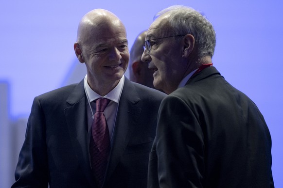 FIFA President Gianni Infantino, left, speaks with Switzerland's Federal President Guy Parmelin, right, at the 56th annual meeting of the World Economic Forum, WEF, in Davos, Switzerland, Wednesd ...