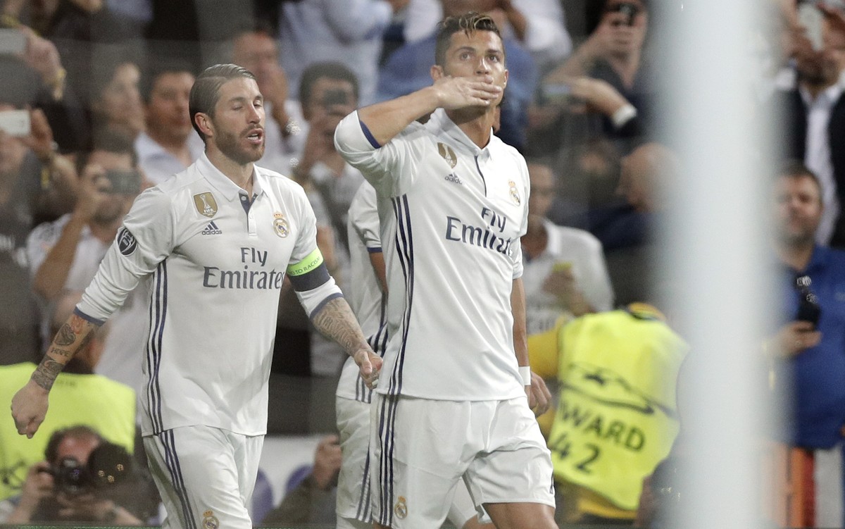 Real Madrid's Cristiano Ronaldo, right, celebrates after scoring his side's first goal during the Champions League quarterfinal second leg soccer match between Real Madrid and Bayern Munich  ...