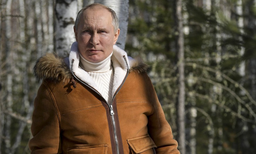In this photo made available on Sunday, March 21, 2021, Russian President Vladimir Putin poses for a photo in a taiga forest in Russia&#039;s Siberian region. Putin and Russia Defense Minister Sergei  ...