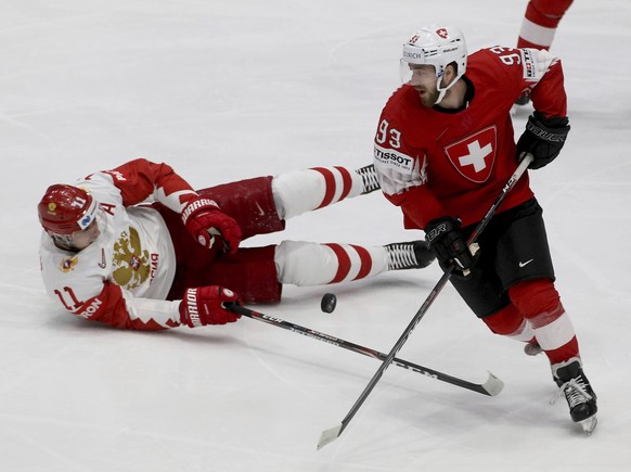 Russia&#039;s Yevgeni Malkin, left, checks Swiss Lino Martschini during the Ice Hockey World Championships group B match between Switzerland and Russia at the Ondrej Nepela Arena in Bratislava, Slovak ...