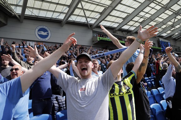 Manchester City fans cheer on the stands before the start of the English Premier League soccer match between Brighton and Manchester City at the AMEX Stadium in Brighton, England, Sunday, May 12, 2019 ...