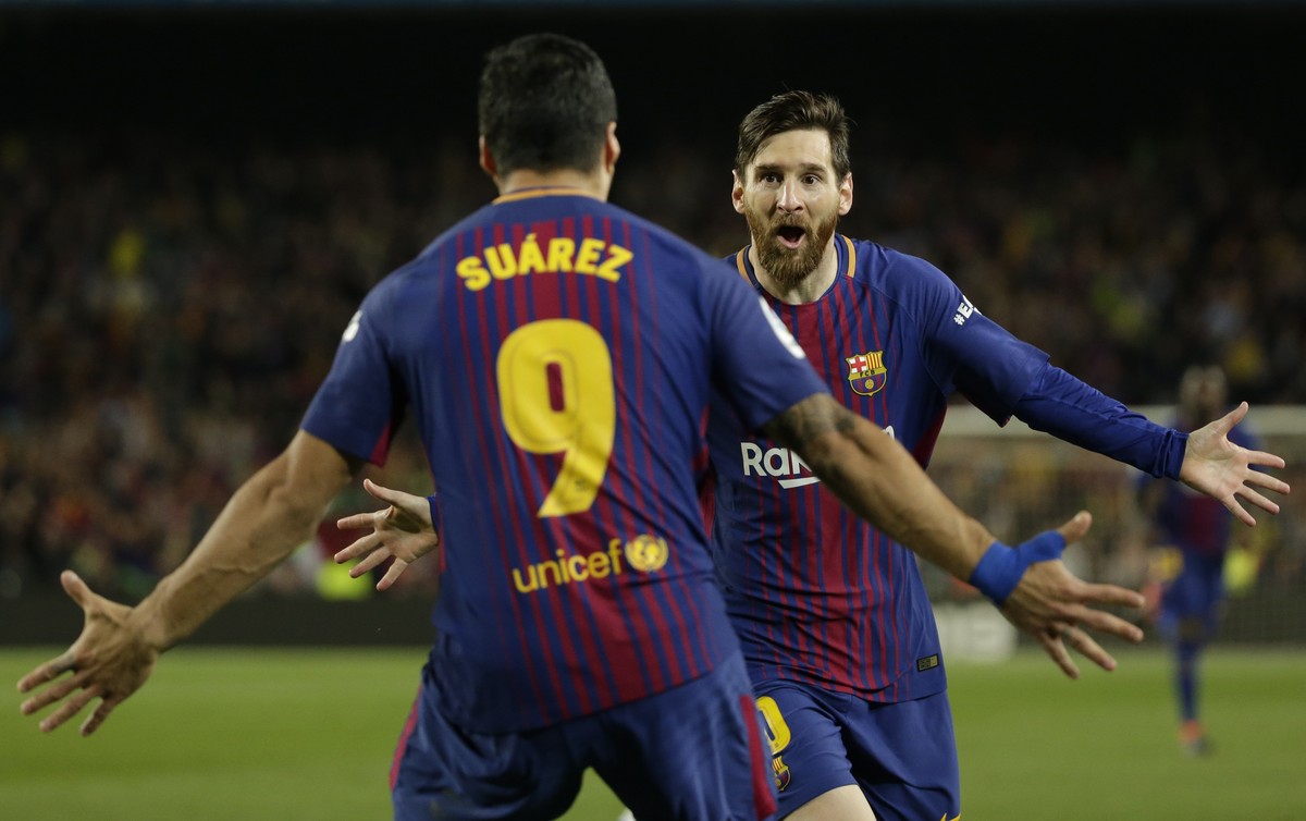 FILE - In this May 6, 2018 file photo Barcelona's Lionel Messi, rear, celebrates with Barcelona's Luis Suarez after scoring his side's second goal during a Spanish La Liga soccer match  ...