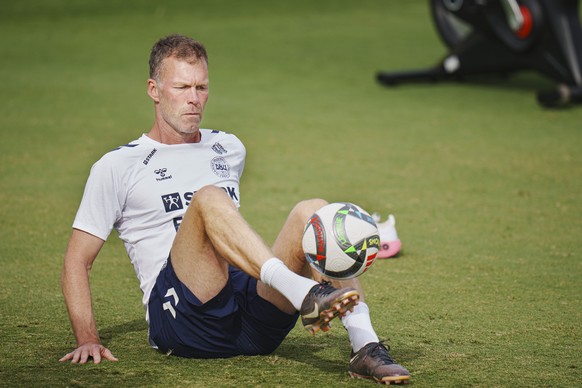 epa11654875 Danish national soccer assistant coach Morten Wieghorst juggles a ball during the team&#039;s training session in Alicante, Spain, 11 October 2024. Denmark will face Spain on 12 October an ...